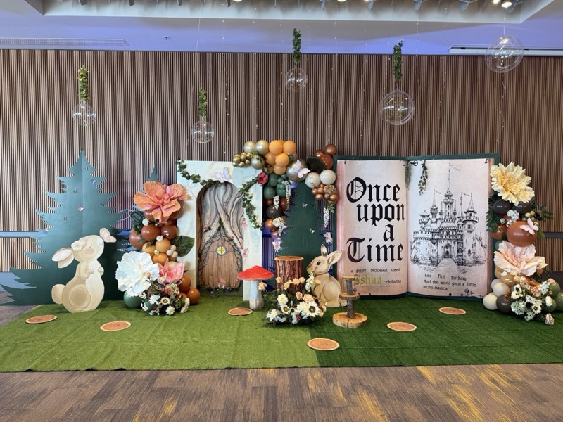 A large storybook-themed celebration installation with handmade scenery