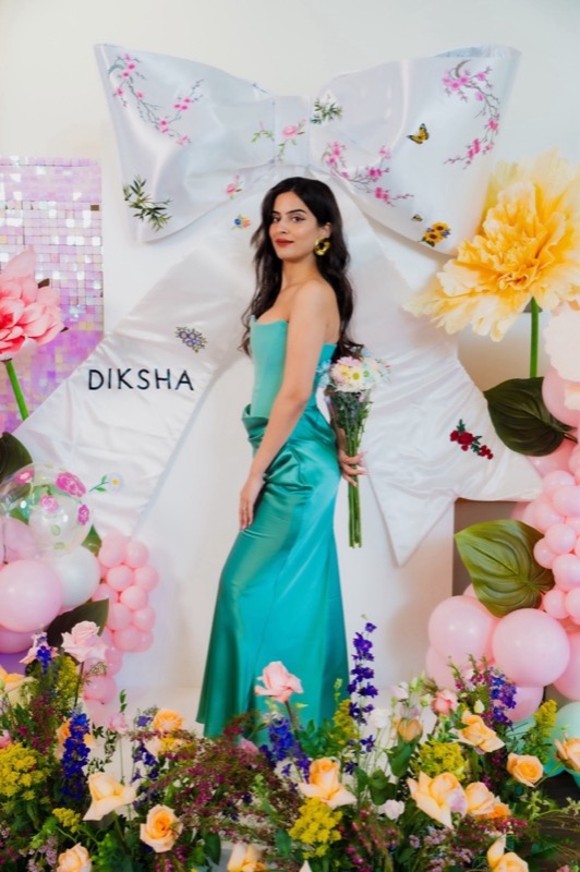 A guest within a colorful celebration installation