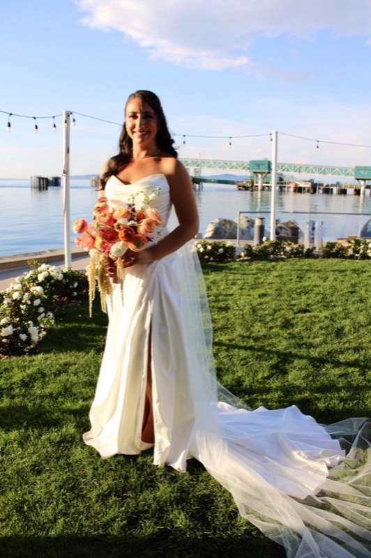 A bride holding a warm-toned bouquet outdoors